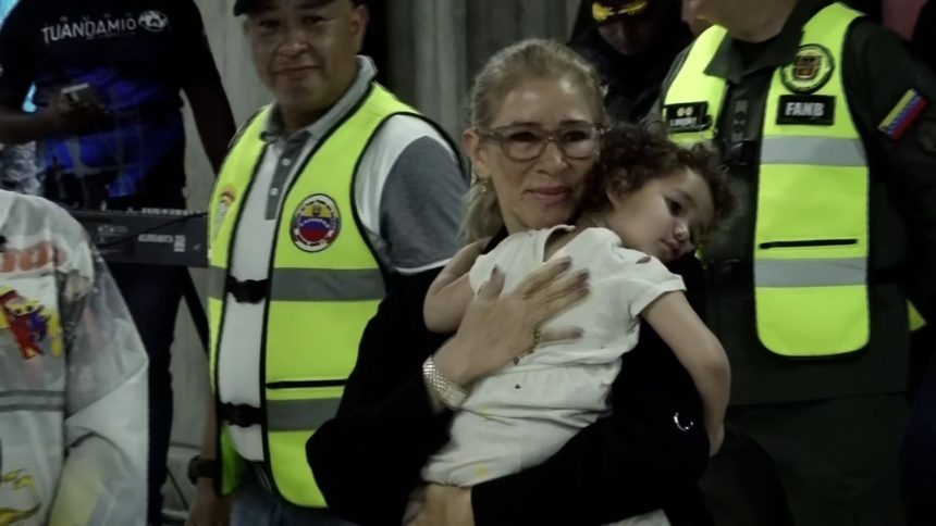 First lady of Venezuela, Cilia Flores, carries Maikelys Antonella Espinoza Bernal upon her return to Venezuela at Simon Bolivar International Airport on May 14, 2025.