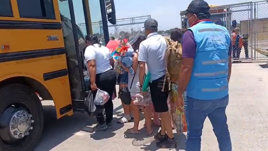 Migrants who self-deported from the US board a bus in Honduras after landing at a local airport.