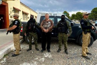 This handout photo shows Konstantin Rudnev guarded by the Airport Security Police in Bariloche, Argentina. Editor’s note: Portions of this photo have been obscured by the authorities.