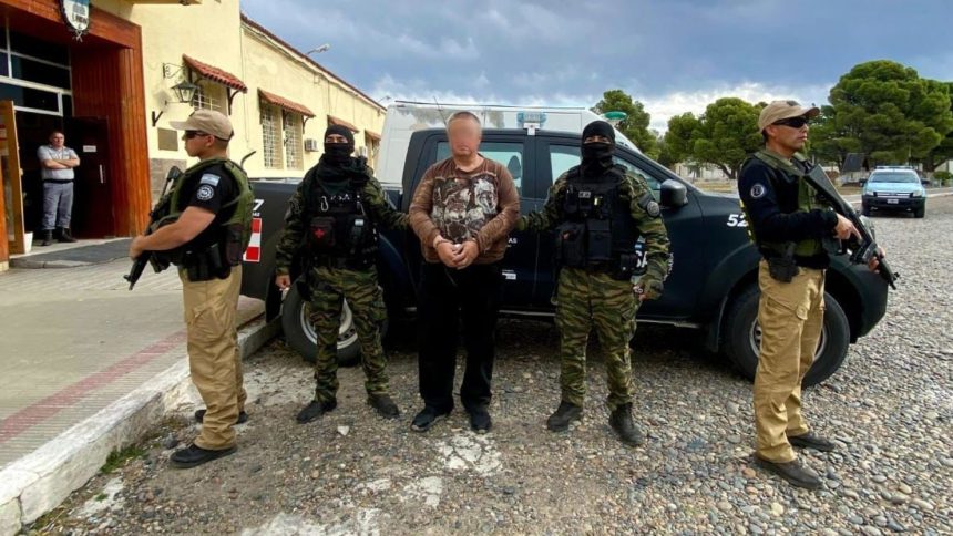 This handout photo shows Konstantin Rudnev guarded by the Airport Security Police in Bariloche, Argentina. Editor’s note: Portions of this photo have been obscured by the authorities.
