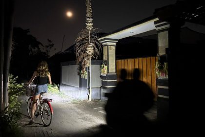 People ride through darkness in Sanur, Bali, as most areas of the Indonesian island, a major tourist hotspot, suffered a major power outage on Friday.