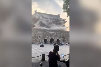 This screengrab taken from a video shows roof tiles collapsing from a centuries-old Chinese drum tower in Anhui, China, on Monday, May 19, 2025.