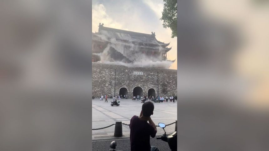 This screengrab taken from a video shows roof tiles collapsing from a centuries-old Chinese drum tower in Anhui, China, on Monday, May 19, 2025.