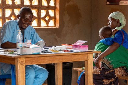 A health worker writes down a child's details after testing for malaria in Lilongwe, Malawi, in an undated photo.