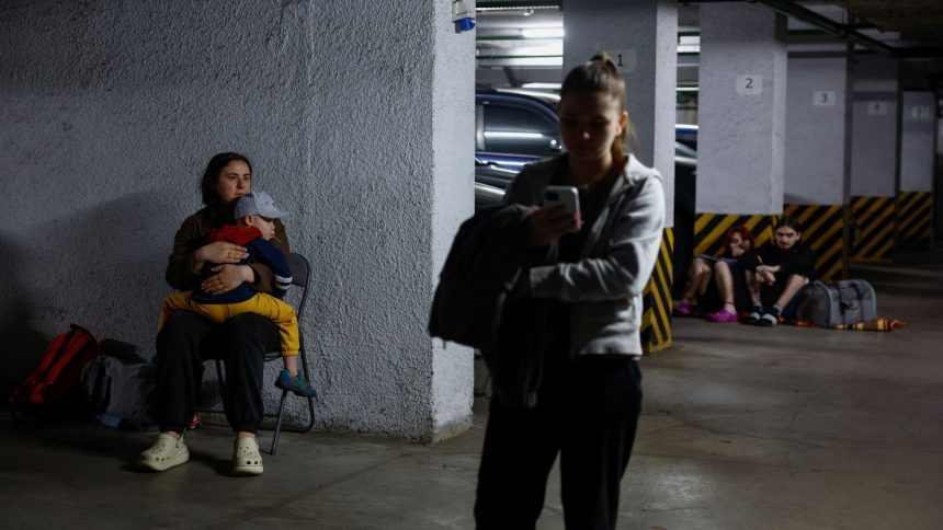 Residents take shelter inside an underground parking during Russian drone and missile strikes, amid Russia's attack on Ukraine, in Kyiv, Ukraine June 6, 2025