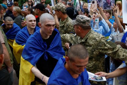 Ukrainian prisoners of war leave a bus as they return after a swap, amid Russia's attack on Ukraine, in an undisclosed location in Ukraine, June 9, 2025.