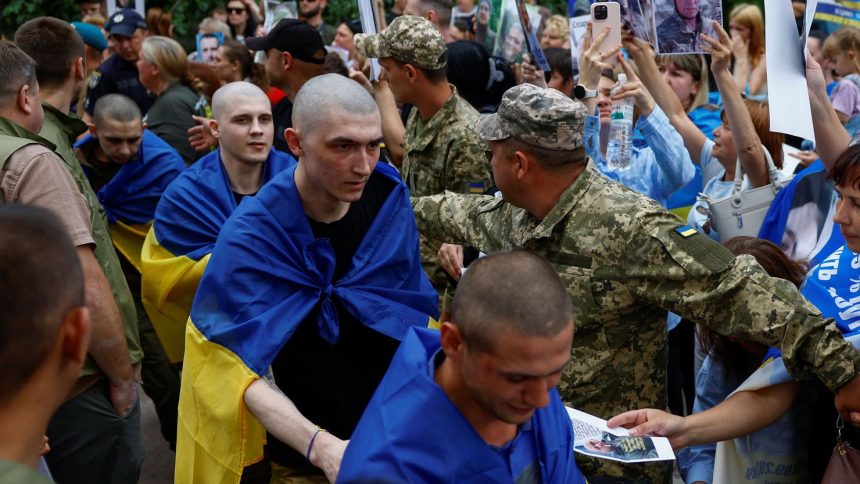 Ukrainian prisoners of war leave a bus as they return after a swap, amid Russia's attack on Ukraine, in an undisclosed location in Ukraine, June 9, 2025.