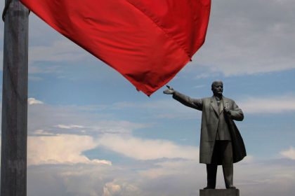 The Kyrgyz flag flies at half staff in front of the statue of Soviet founder Vladimir Lenin in Osh, Kyrgyzstan, in 2010.