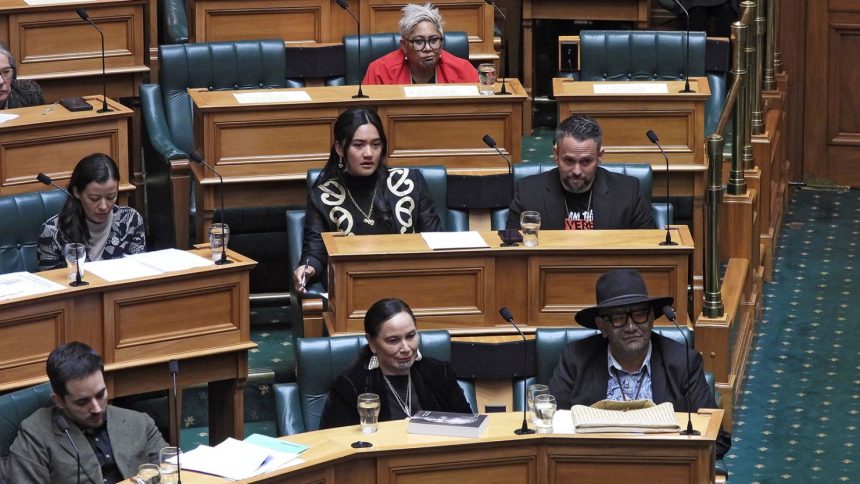 New Zealand lawmakers, Hana-Rāwhiti Maipi-Clarke, center at second row, Debbie Ngarewa-Packer, center in front row, and Rawiri Waititi, bottom right, watch as legislators debate their proposed bans in Wellington, New Zealand on June 5, 2025.