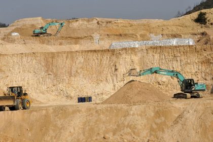 Workers use machinery to dig at a rare earth mine in Ganxian county in central China's Jiangxi province in 2010.