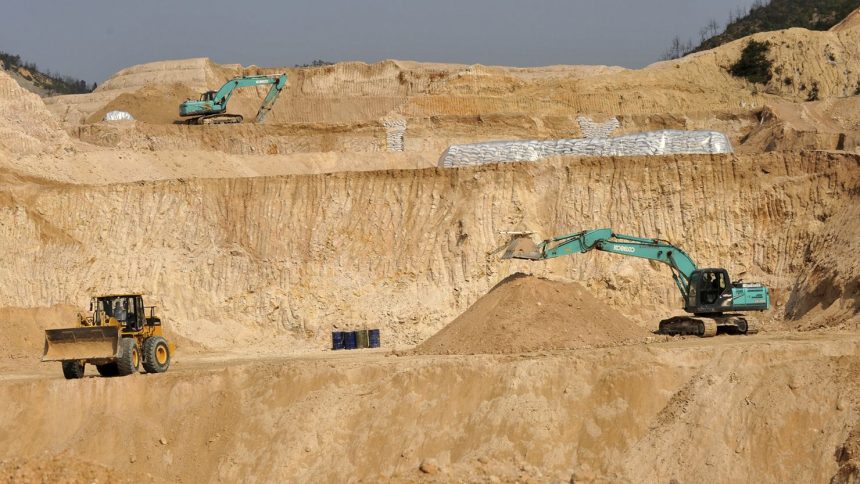 Workers use machinery to dig at a rare earth mine in Ganxian county in central China's Jiangxi province in 2010.