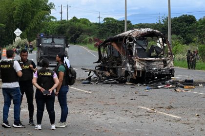 Police officers work at the site where a bus exploded in front of a police station in Villa Rica, Cauca department, Colombia, on June 10.