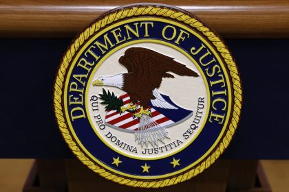 A seal for the Department of Justice is seen on a podium ahead of a news conference at the Department of Justice Building on March 21, 2024, in Washington, DC.