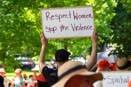 An attendee holds a sign during a march demanding an end to domestic violence and femicide in Melbourne, Australia, on November 22, 2024.