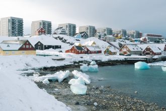 Painted houses and residential apartment blocks overlook the fjord in Nuuk, Greenland, on April 3.