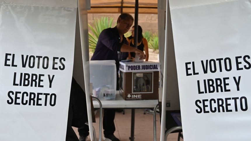 A voter casts his ballot at a ''special'' ballot box zone installed for people living outside the border city of Tijuana on June 1, 2025.