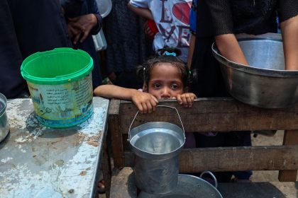 A girl waits with others to receive food at a distribution point in Nuseirat, central Gaza, on June 2.
