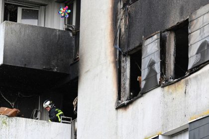 A firefighter secures an apartment building where a blaze broke out overnight in Reims on June 6.