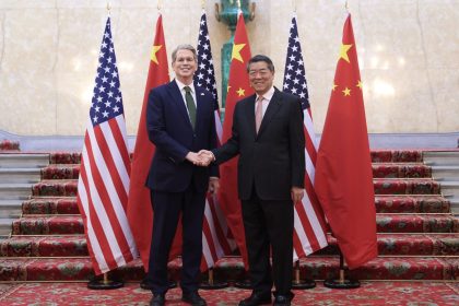 Chinese Vice Premier He Lifeng shakes hands with US Treasury Secretary Scott Bessent in London on Monday.