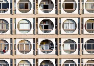 Abu Dhabi-based photographer Hussain AlMoosawi is documenting the architecture of the United Arab Emirates to understand its rapidly evolving urban landscape. Born in 1984, he found himself drawn to early modern architecture, like the Obeid Al Mazrouei building in Abu Dhabi (pictured). Also known as the “Connect Four” building, this 10-story residential building from the 1980s has a striking facade of circle frames, offering shade and privacy to the terraces behind. Look through the gallery to see more distinctive architecture from Abu Dhabi and the Emirates.