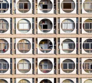 Abu Dhabi-based photographer Hussain AlMoosawi is documenting the architecture of the United Arab Emirates to understand its rapidly evolving urban landscape. Born in 1984, he found himself drawn to early modern architecture, like the Obeid Al Mazrouei building in Abu Dhabi (pictured). Also known as the “Connect Four” building, this 10-story residential building from the 1980s has a striking facade of circle frames, offering shade and privacy to the terraces behind. Look through the gallery to see more distinctive architecture from Abu Dhabi and the Emirates.